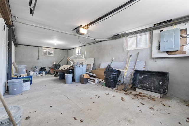 garage featuring electric panel and a garage door opener