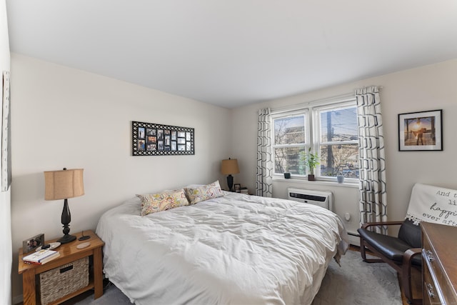 bedroom featuring an AC wall unit and baseboard heating