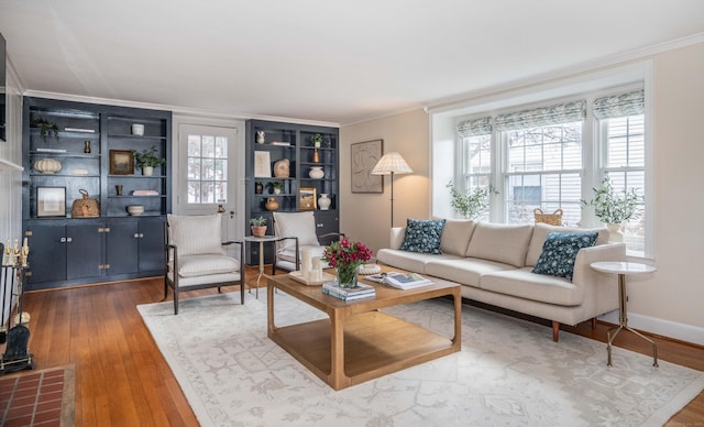 living room with a wealth of natural light, baseboards, hardwood / wood-style floors, and crown molding