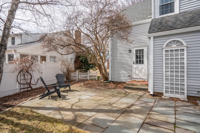 view of patio featuring entry steps and fence