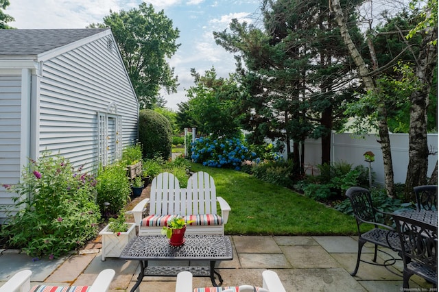 view of yard with outdoor dining space, a patio area, and fence