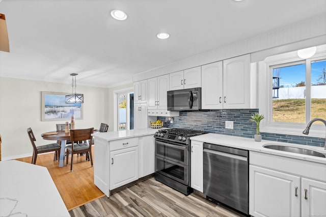 kitchen with a sink, appliances with stainless steel finishes, and white cabinetry