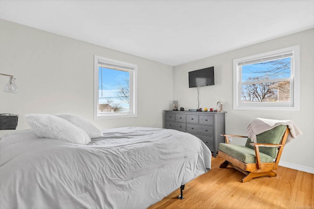 bedroom with wood finished floors and baseboards