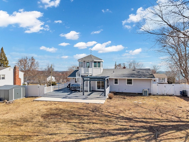 back of property with a patio, central AC unit, a fenced backyard, and a gate