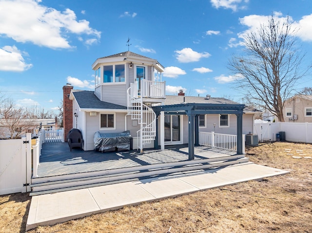 back of property featuring a gate, central AC unit, a wooden deck, a fenced backyard, and a pergola