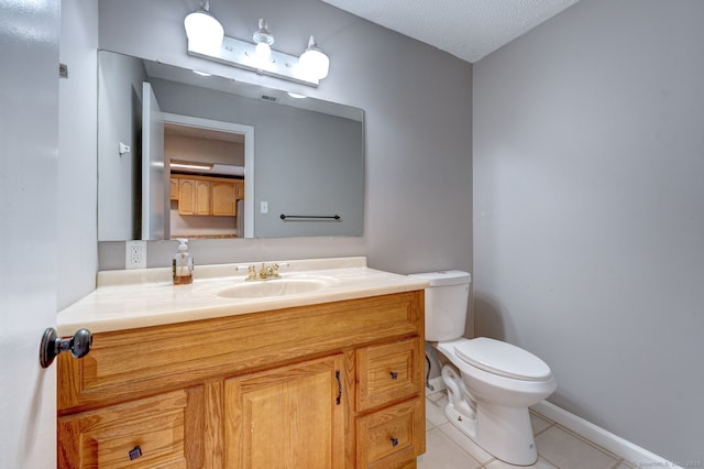 half bath featuring vanity, tile patterned floors, toilet, and a textured ceiling