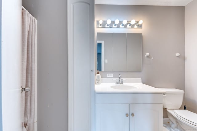 bathroom featuring toilet and vanity