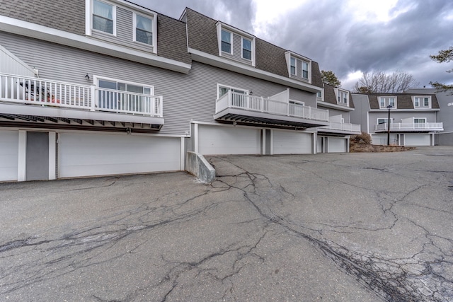 view of property with an attached garage and driveway