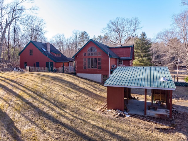 back of property with a lawn