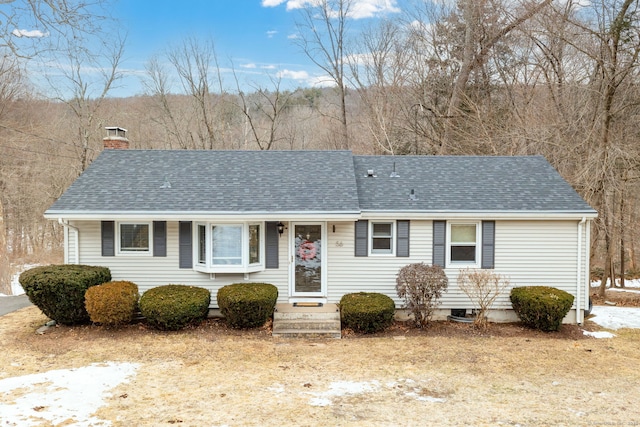 single story home featuring roof with shingles and a chimney