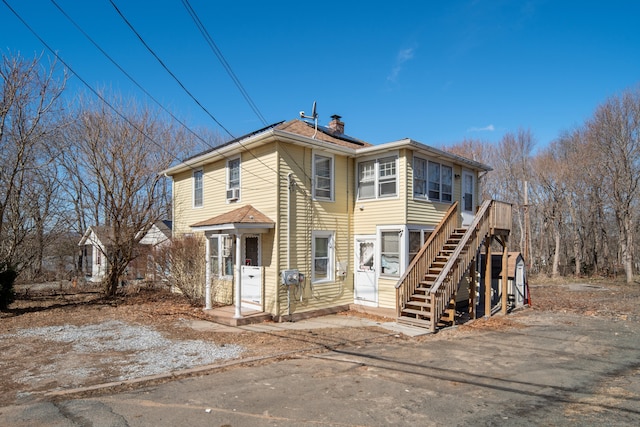 view of front of home featuring solar panels and a chimney