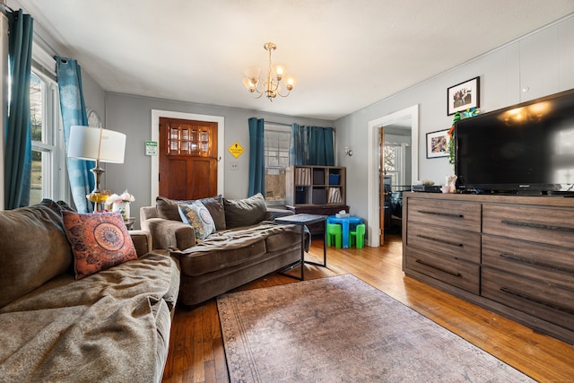 living area featuring wood-type flooring and an inviting chandelier