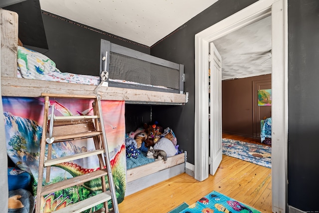 bedroom with wood finished floors and baseboards