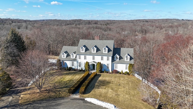 bird's eye view with a wooded view