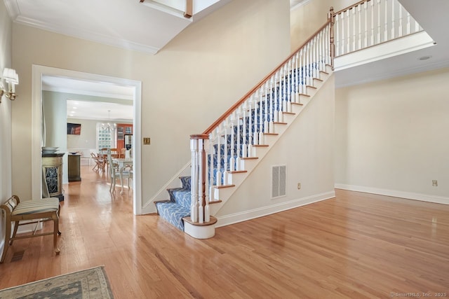 35 Grace View Dr, Easton, CT 06612 - entrance foyer with wood finished floors, stairway, a chandelier, and crown molding