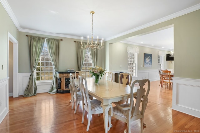 35 Grace View Dr, Easton, CT 06612 - dining area with a chandelier, a decorative wall, light wood-style floors, wainscoting, and ornamental molding