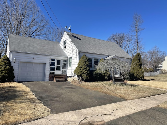 view of front of property with driveway, roof with shingles, an attached garage, and entry steps