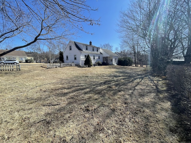 view of home's exterior featuring a yard and a chimney