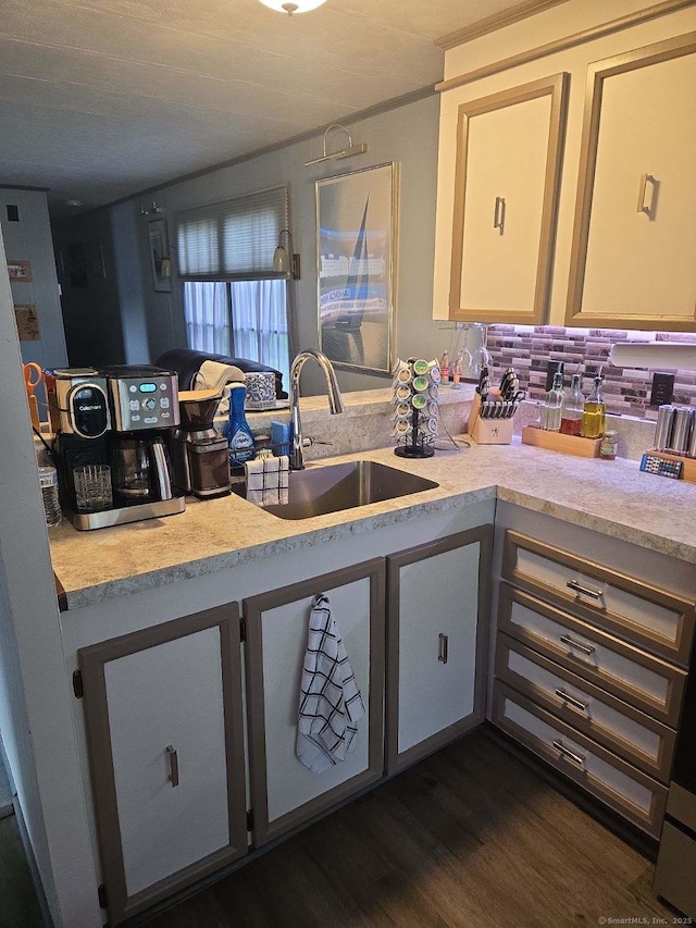 kitchen with light countertops, dark wood-style floors, and a sink