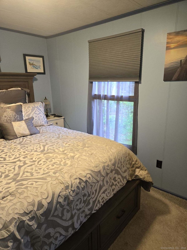 carpeted bedroom with ornamental molding