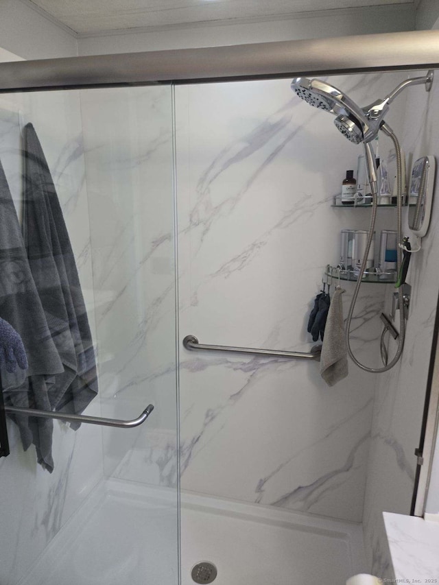 full bath featuring a marble finish shower