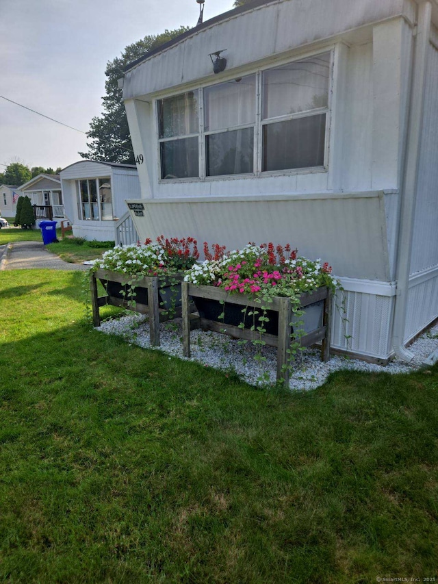 view of side of home featuring a lawn