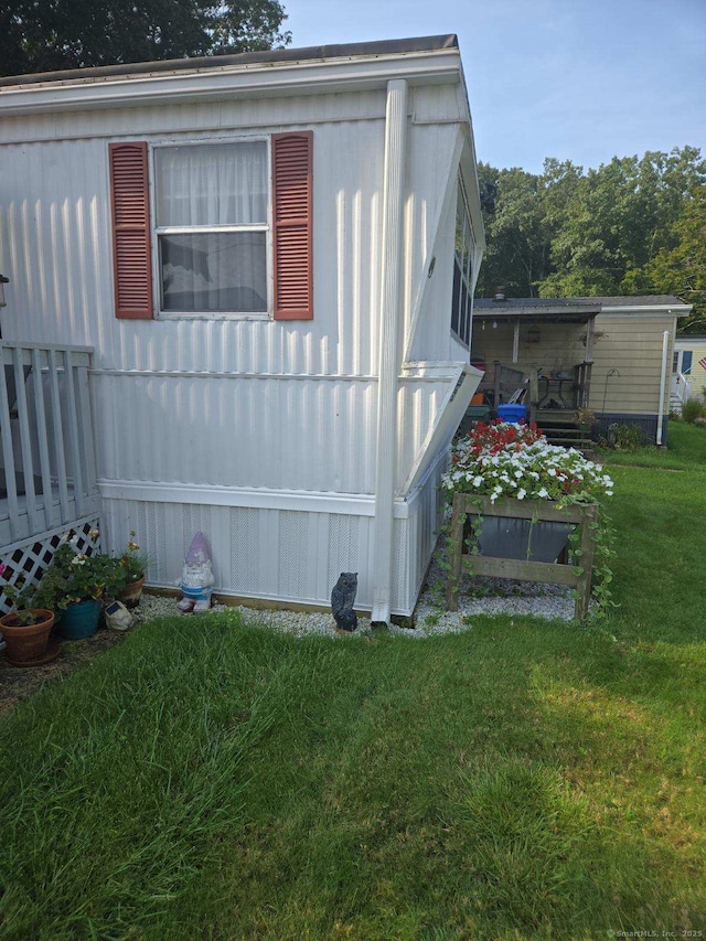 view of side of home with a lawn