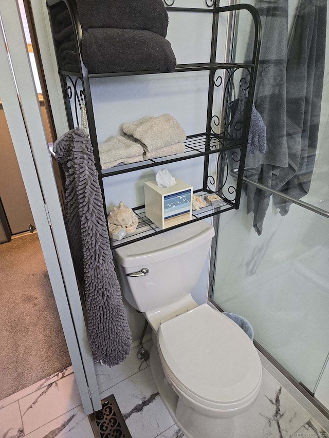 bathroom featuring toilet and marble finish floor