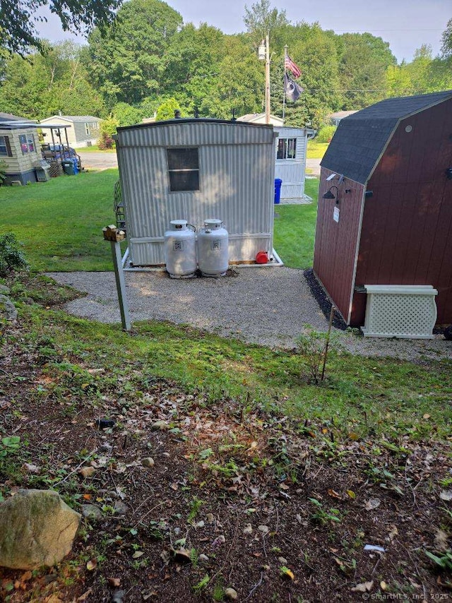 view of yard with an outbuilding and a storage shed