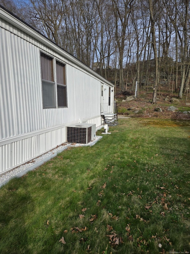 301 Buddington Rd Lot 49, Groton, CT 06340 - view of side of home with a central AC unit and a lawn