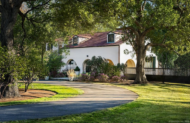 view of community with a yard and fence