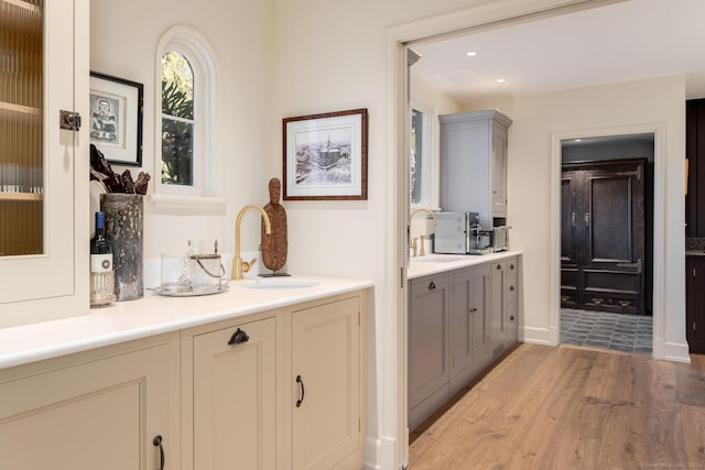 interior space featuring recessed lighting, light wood-style flooring, and a sink