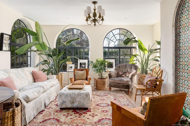 living room with an inviting chandelier and wood finished floors