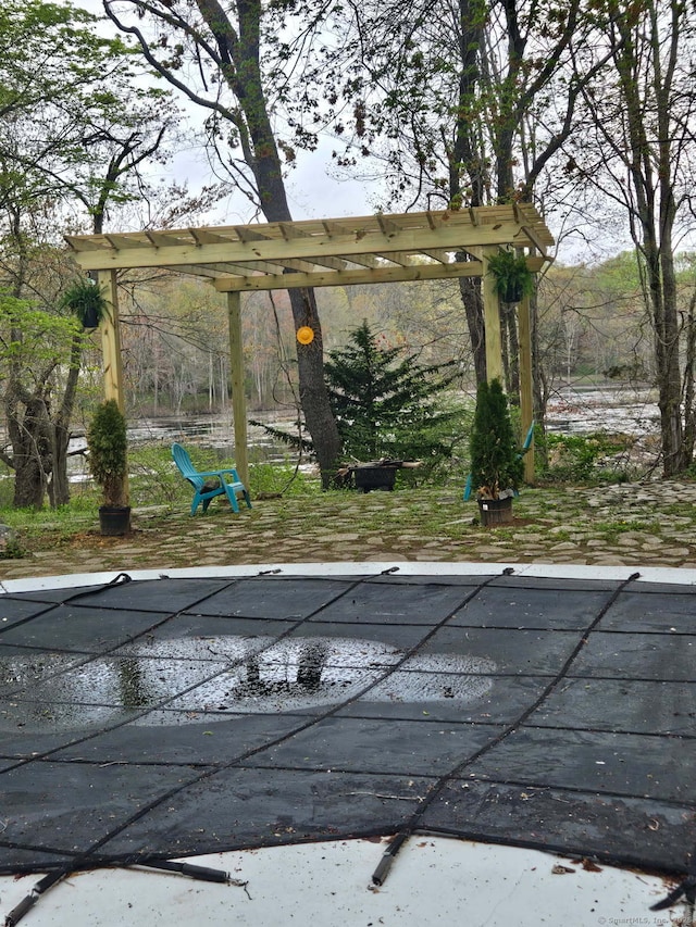 view of pool featuring a wooden deck and a covered pool