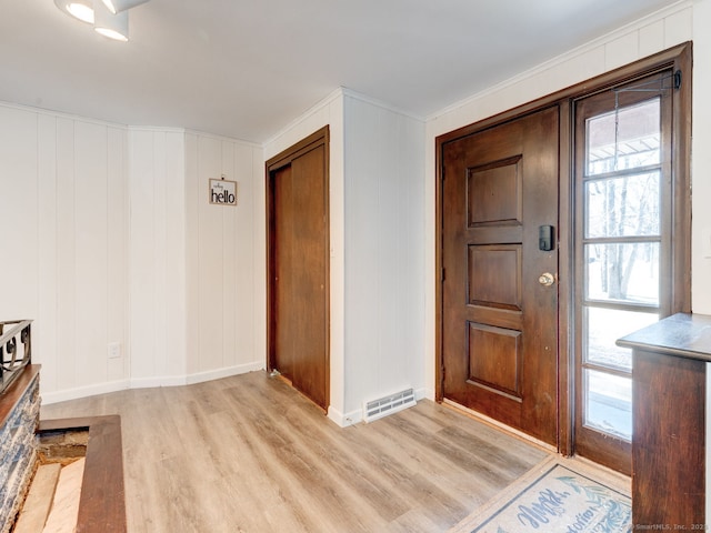 entrance foyer with visible vents, baseboards, and light wood-style flooring