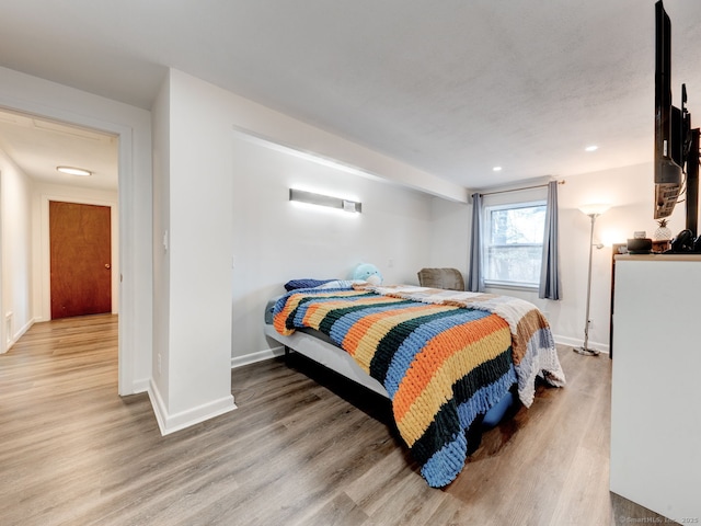 bedroom featuring recessed lighting, light wood-style floors, and baseboards