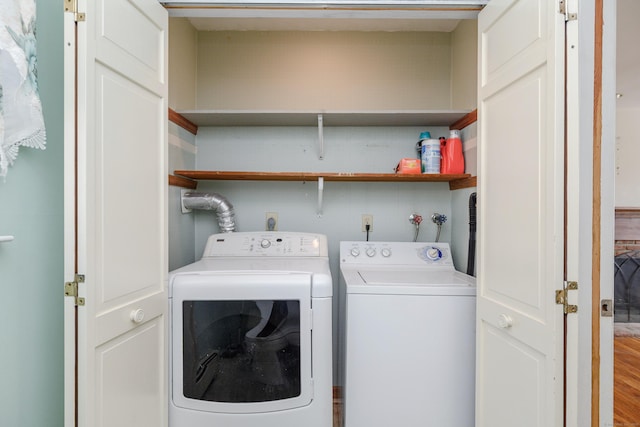 clothes washing area with separate washer and dryer and laundry area