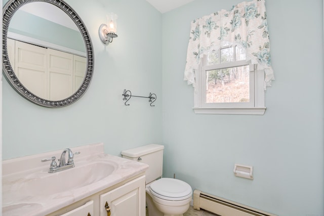 bathroom with baseboard heating, toilet, and vanity