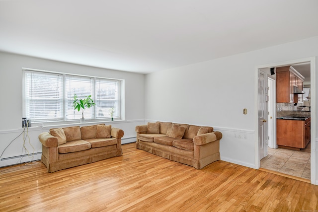 living area featuring light wood finished floors and baseboard heating