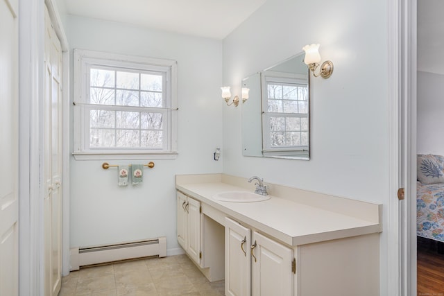 bathroom with vanity, tile patterned floors, baseboard heating, and connected bathroom