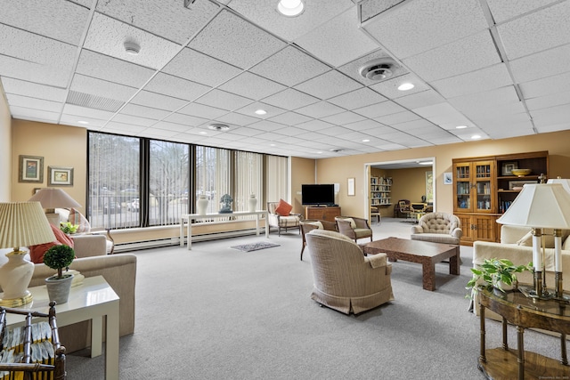 living area with visible vents, carpet floors, recessed lighting, a paneled ceiling, and a baseboard heating unit