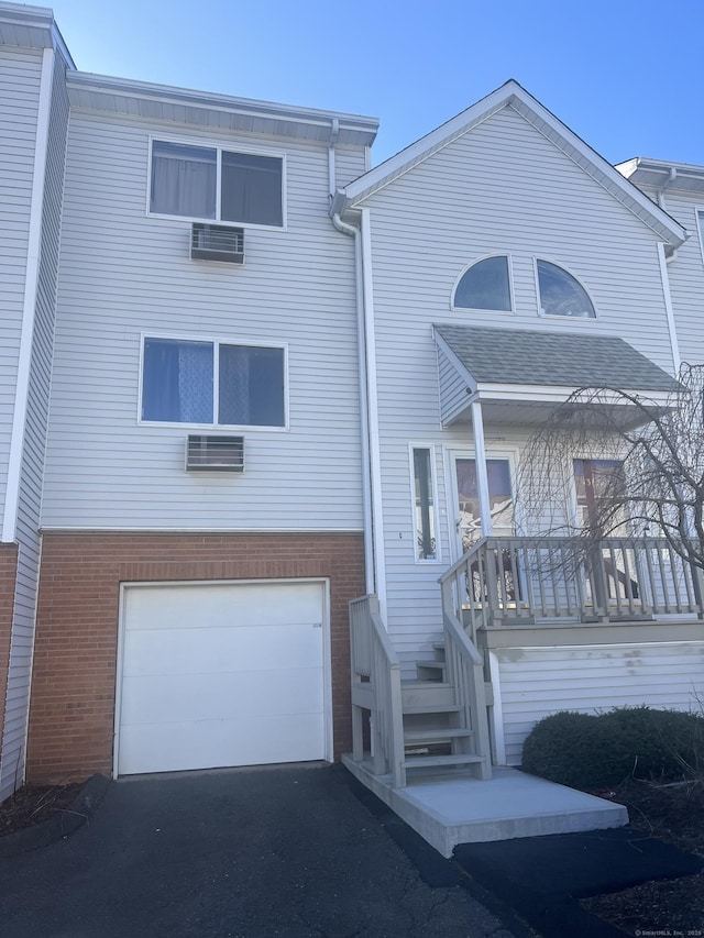 view of front of house with brick siding, driveway, and a garage