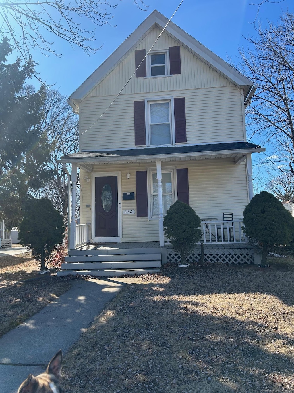 american foursquare style home featuring covered porch