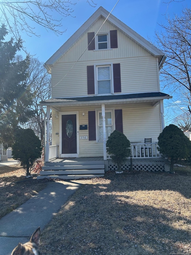 american foursquare style home featuring covered porch