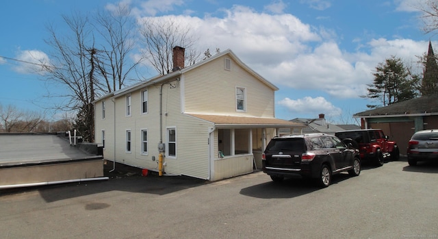 view of side of home featuring a chimney