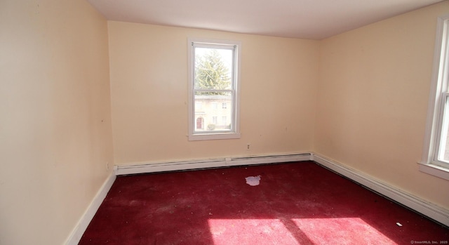 carpeted spare room with a baseboard heating unit, baseboards, and baseboard heating