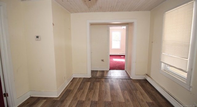 hall with a baseboard radiator, baseboards, and wood finished floors