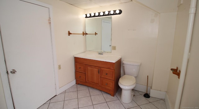 bathroom featuring tile patterned floors, toilet, vanity, and baseboards