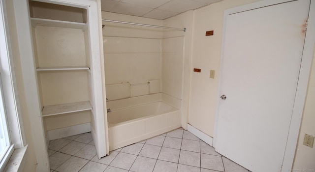 bathroom with tile patterned flooring, shower / tub combination, and a paneled ceiling