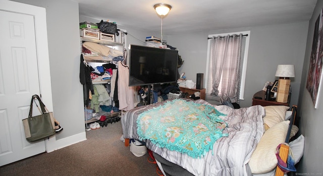 bedroom with carpet flooring and baseboards